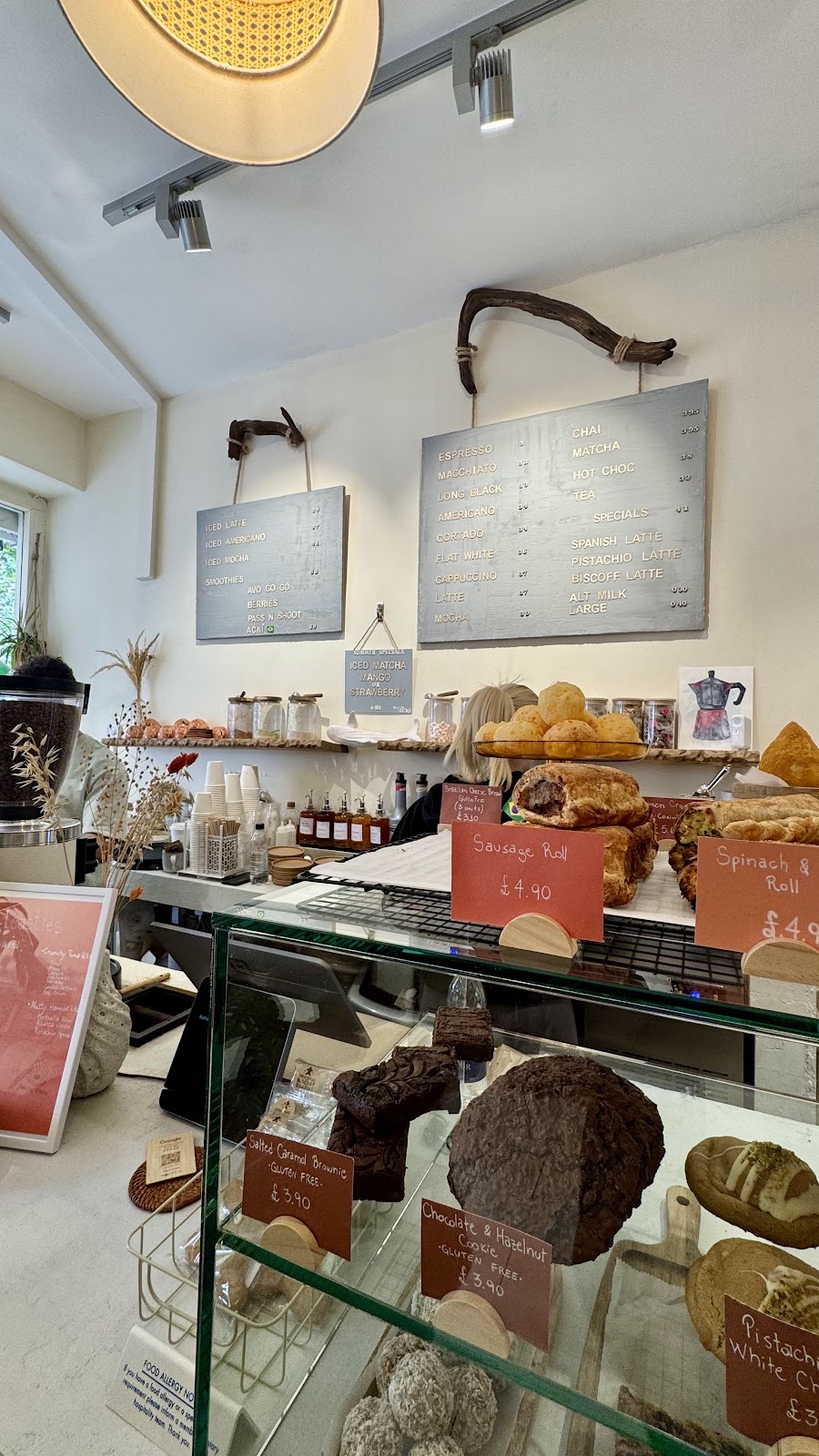 The service counter and cake cabinet under pendant lighting, cropped to the counter and display so the burned-in words fall outside frame