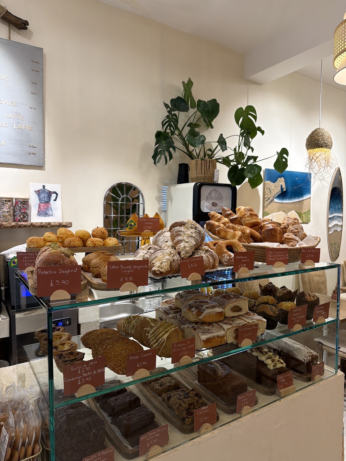 Tray bakes and cakes in the glass cabinet, cropped tight to the shelves so the burned-in words fall outside frame
